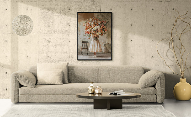 Black-framed flower market art print hanging above a wide beige sofa in a concrete-walled living room