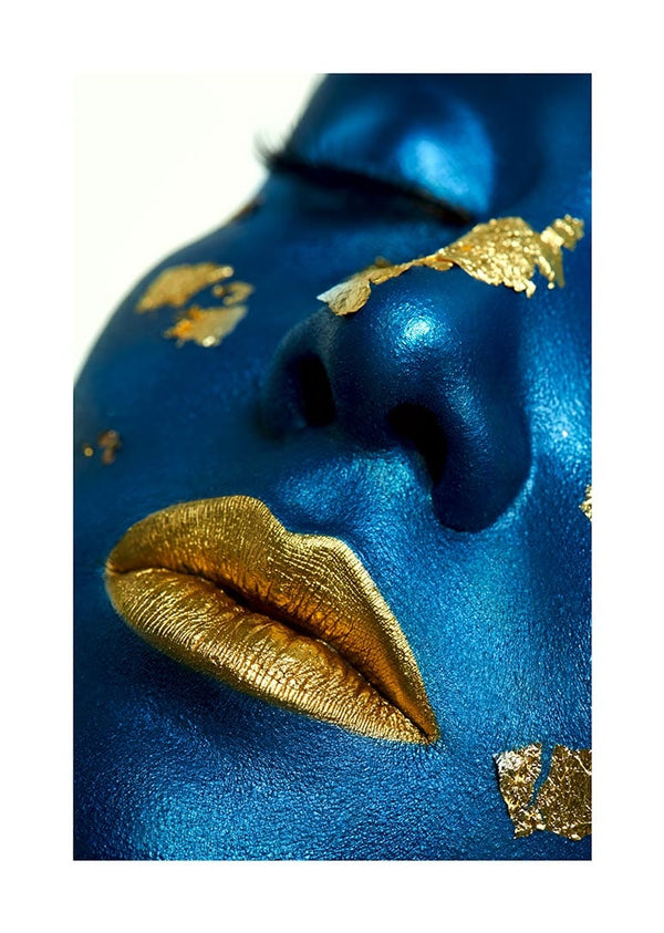 Close-up of blue-painted face with metallic golden lips and gold leaf accents, featured on a decorative poster.