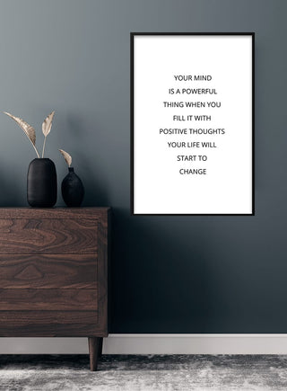 Minimalist "Your Mind Is Powerful" poster on wall above wooden dresser in modern room decor.