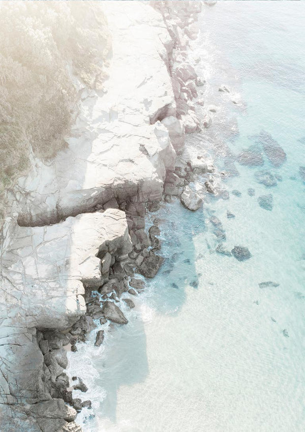 Aerial view of a rocky beach with turquoise water featured on the Rocky Beach Plakat product page.