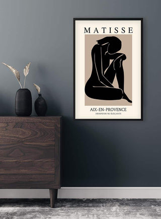 Framed Matisse Inspired Black Nude Plakat hanging above a modern wooden dresser with minimalist decor.