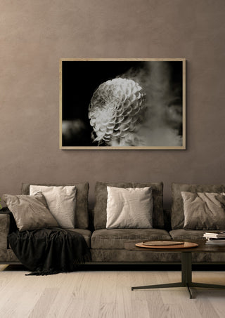 Lunar Bloom III by Guido Lucker in a light wood frame above a grey sofa with cushions