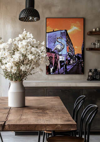 Brick Lane Pelican by Pelecan Schneider in a black frame above a rustic table with white flowers