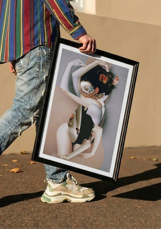 Pebbles by Rocio Montoya carried in a black frame along a sunny street
