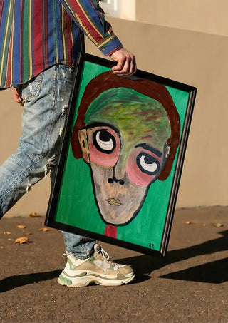 Hjärnspöken by RR carried in a black frame along a sunny street
