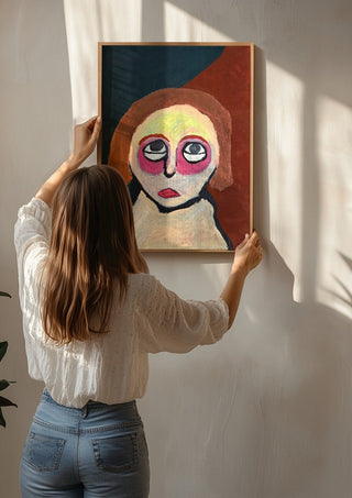 Kreativ by RR being hung on a sunlit wall