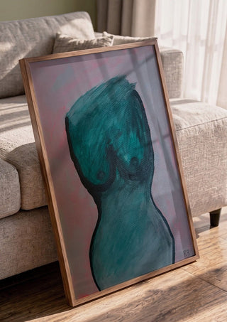 Kroppen by RR in a walnut frame leaning against a grey sofa