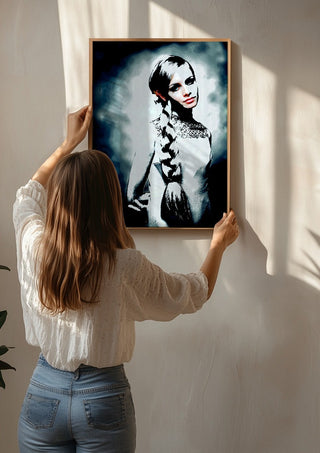 Twiggy by Pelecan Schneider being hung on a sunlit wall