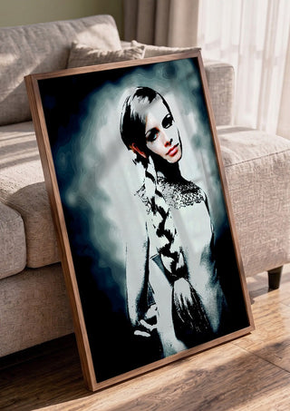 Twiggy by Pelecan Schneider in a walnut frame leaning against a grey sofa