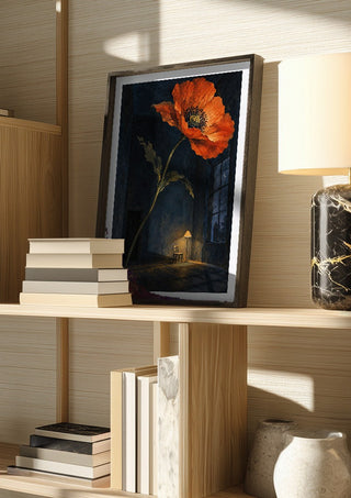 Poppy After Midnight by Matthews Gallerie in a dark frame on a wooden shelf beside books and a lamp