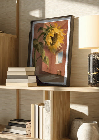 A Window for the Sun by Matthews Gallerie in a dark frame on a wooden shelf beside books and a lamp
