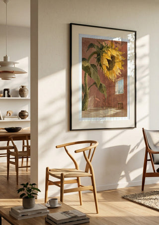 A Window for the Sun by Matthews Gallerie in a black frame in a bright dining room with wooden chairs
