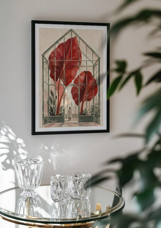 The Red Conservatory by Matthews Gallerie in a black frame above a glass table with crystal glassware