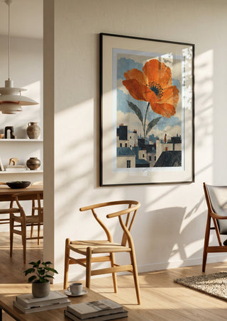 Blooming Above the Roofs by Matthews Gallerie in a black frame in a bright dining room with wooden chairs