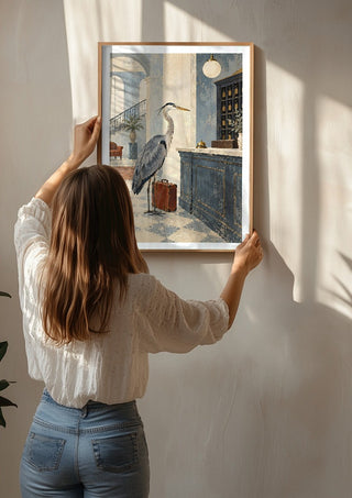 The Heron Checks In by Matthews Gallerie being hung on a sunlit wall