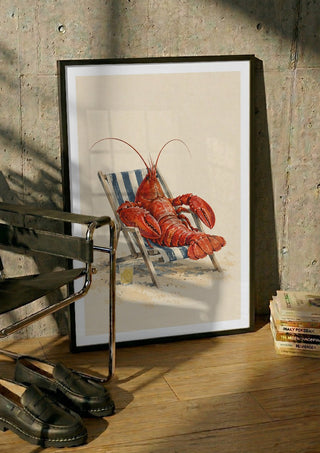 The Lobster’s Day Off by Matthews Gallerie in a black frame leaning against a concrete wall by a steel chair