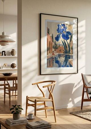 The Blue Garden by Matthews Gallerie in a black frame in a bright dining room with wooden chairs