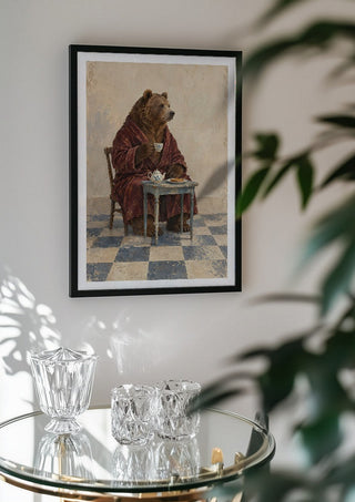 Tea Before Noon by Matthews Gallerie in a black frame above a glass table with crystal glassware