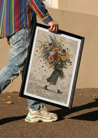 Carrying Spring by Matthews Gallerie carried in a black frame along a sunny street