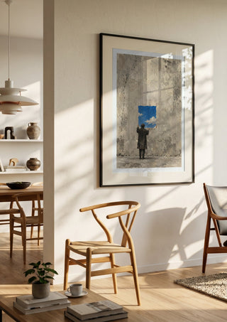 Borrowed Sky by Matthews Gallerie in a black frame in a bright dining room with wooden chairs