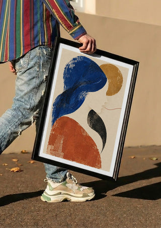 The Shape of Silence by Matthews Gallerie carried in a black frame along a sunny street