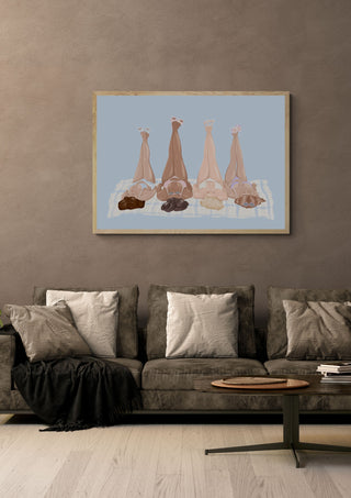Girls at the beach by Lisen Vennesland in a light wood frame above a grey sofa with cushions