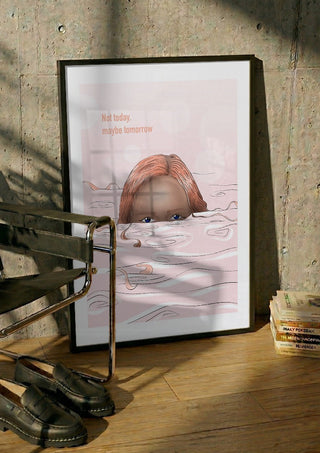 Maybe tomorrow by Lisen Vennesland in a black frame leaning against a concrete wall by a steel chair