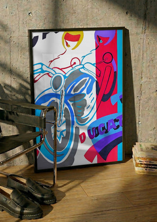 Homage to ducati by NKo in a black frame leaning against a concrete wall by a steel chair