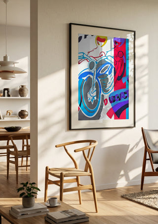 Homage to ducati by NKo in a black frame in a bright dining room with wooden chairs