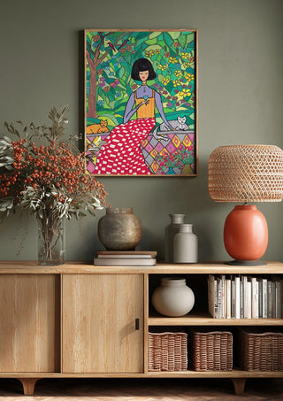 The Garden Wall by Camilla Nilsson above a wooden sideboard on a sage green wall
