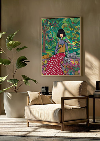 The Garden Wall by Camilla Nilsson framed above a beige armchair beside a potted plant