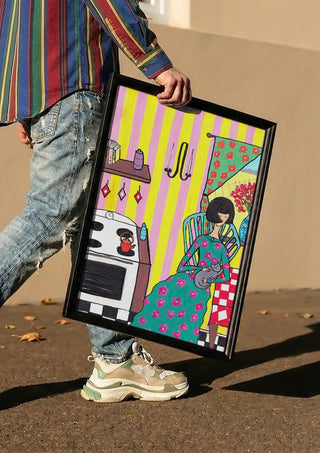 Afternoon with the Cat by Camilla Nilsson carried in a black frame along a sunny street