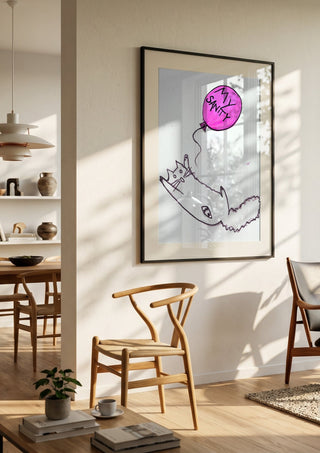 My Sanity by Camilla Nilsson in a black frame in a bright dining room with wooden chairs