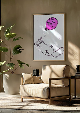 My Sanity by Camilla Nilsson framed above a beige armchair beside a potted plant
