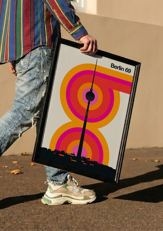 Berlin 69 by Bo Lundberg carried in a black frame along a sunny street
