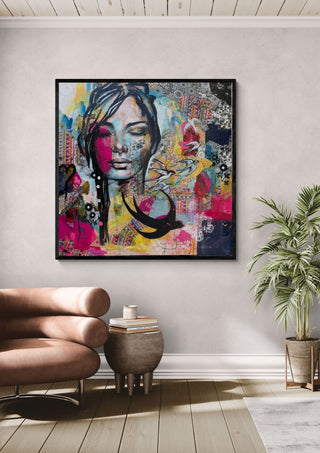 Ende des Sommers by Anke Fillies in a black frame on a pale wall beside a leather armchair and a palm