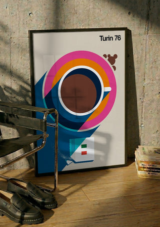 Turin 76 by Bo Lundberg in a black frame leaning against a concrete wall by a steel chair