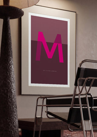 M as in Mind-blowing – Cerise by Quite Nice Prints framed in a dim room beside a tubular steel chair