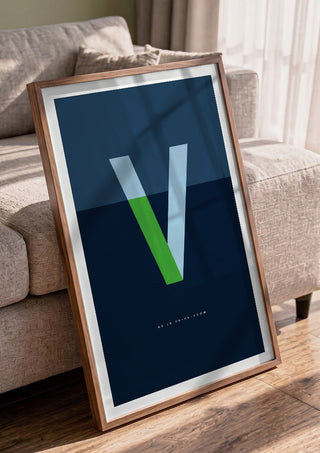 V as in Va-va-voom – Blue by Quite Nice Prints in a walnut frame leaning against a grey sofa