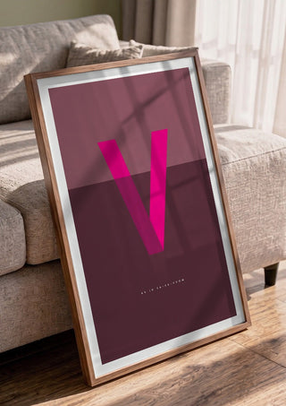 V as in Va-va-voom – Cerise by Quite Nice Prints in a walnut frame leaning against a grey sofa