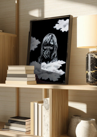 innocence by Sofia de Lemos in a dark frame on a wooden shelf beside books and a lamp