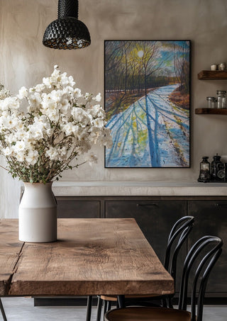 Shadows of the Day by Finbar Stevens in a black frame above a rustic table with white flowers