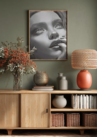 the dreamer by Sofia de Lemos above a wooden sideboard on a sage green wall
