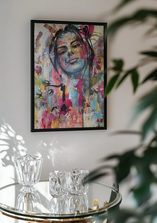 Sehnsucht by Anke Fillies in a black frame above a glass table with crystal glassware