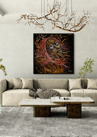 forest witch by Sofia de Lemos in a black frame above a beige sofa under a branch chandelier