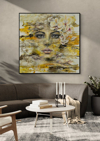 Symbiose by Anke Fillies in a black frame above a grey sofa with candlesticks on a round table