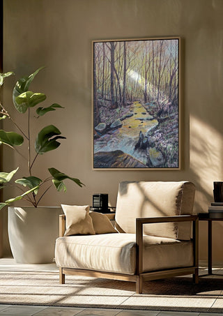 The Evening Stream by Finbar Stevens framed above a beige armchair beside a potted plant