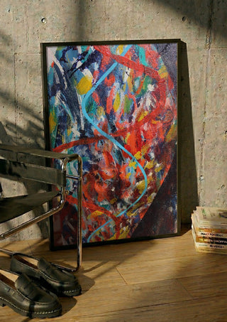 Spiral, the code of life. by António D'Albuquerque in a black frame leaning against a concrete wall by a steel chair