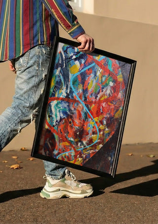 Spiral, the code of life. by António D'Albuquerque carried in a black frame along a sunny street