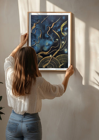 Gold Ribbons at Night by luco art being hung on a sunlit wall